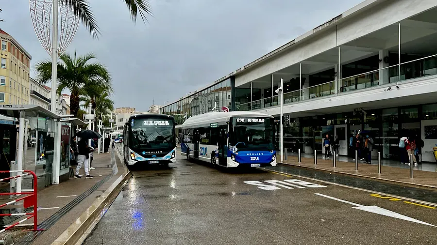 Local buses at the Cannes bus station on a rainy day