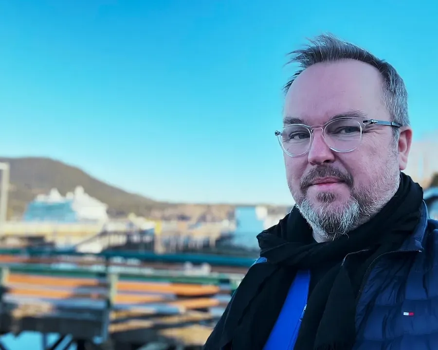 Patrick Hughes with a blurred Royal Caribbean ship in the background - taken in Alaska