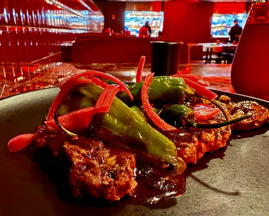 Grilled meat with peppers and onions served at Lucky Lotus restaurant