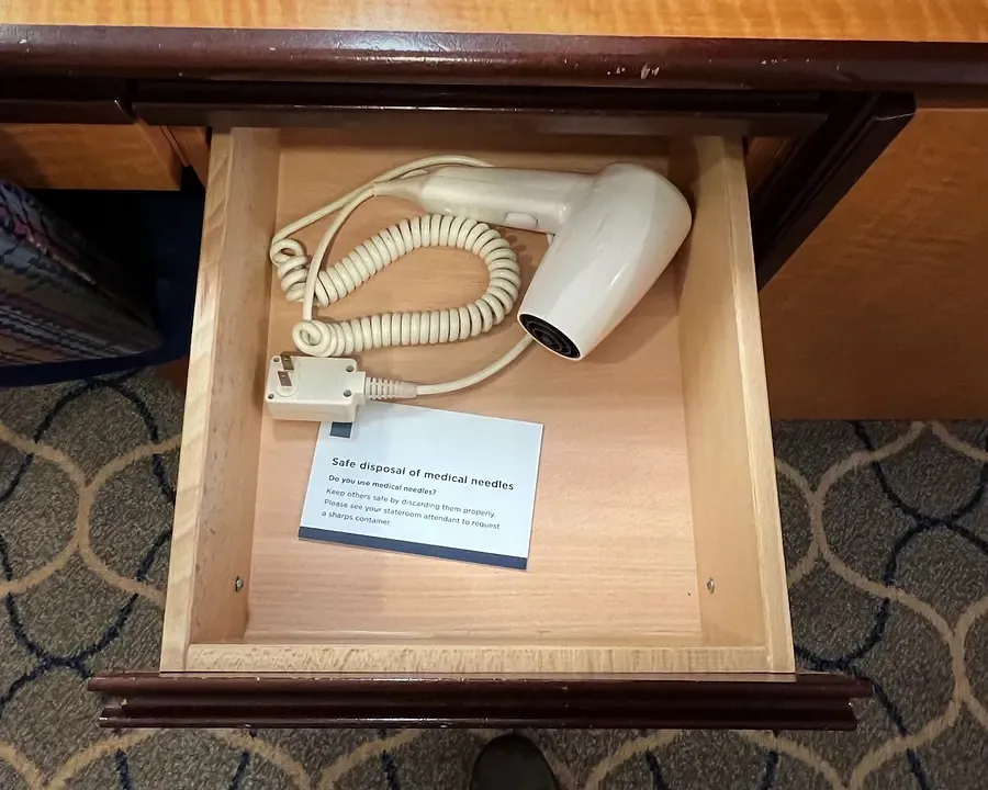 A hair dryer inside an open drawer