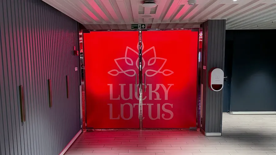 Red Lucky Lotus entrance doors with lotus logo on Virgin Voyages Scarlet Lady