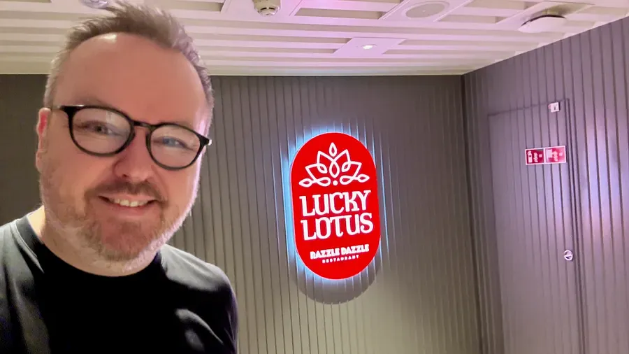 Selfie next to the illuminated Lucky Lotus sign on Scarlet Lady