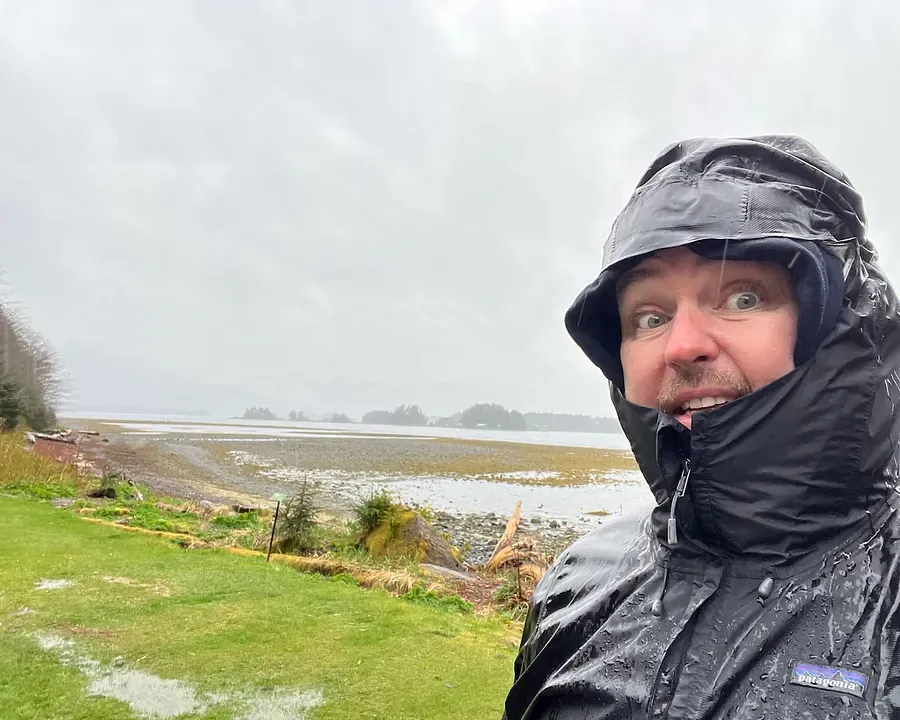 Patrick Hughes drenched by the rain in a black waterproof jacket