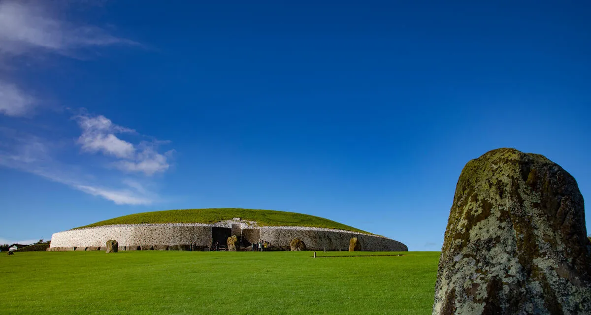 The entrance to Newgrange passage tomb with its white quartz facade and carved entrance stone, County Meath
