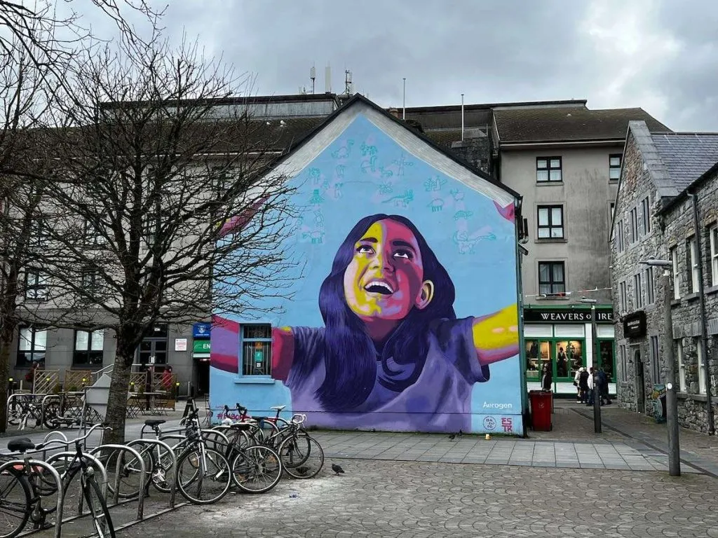 A bright mural showing a. young girl in Galway