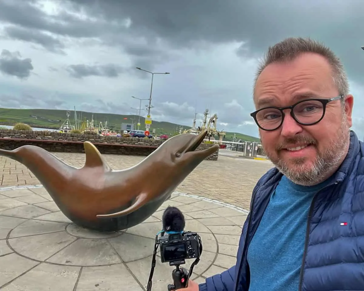 Patrick at the statue of local celebrity dolphin, Fungie, at Dingle Harbour.