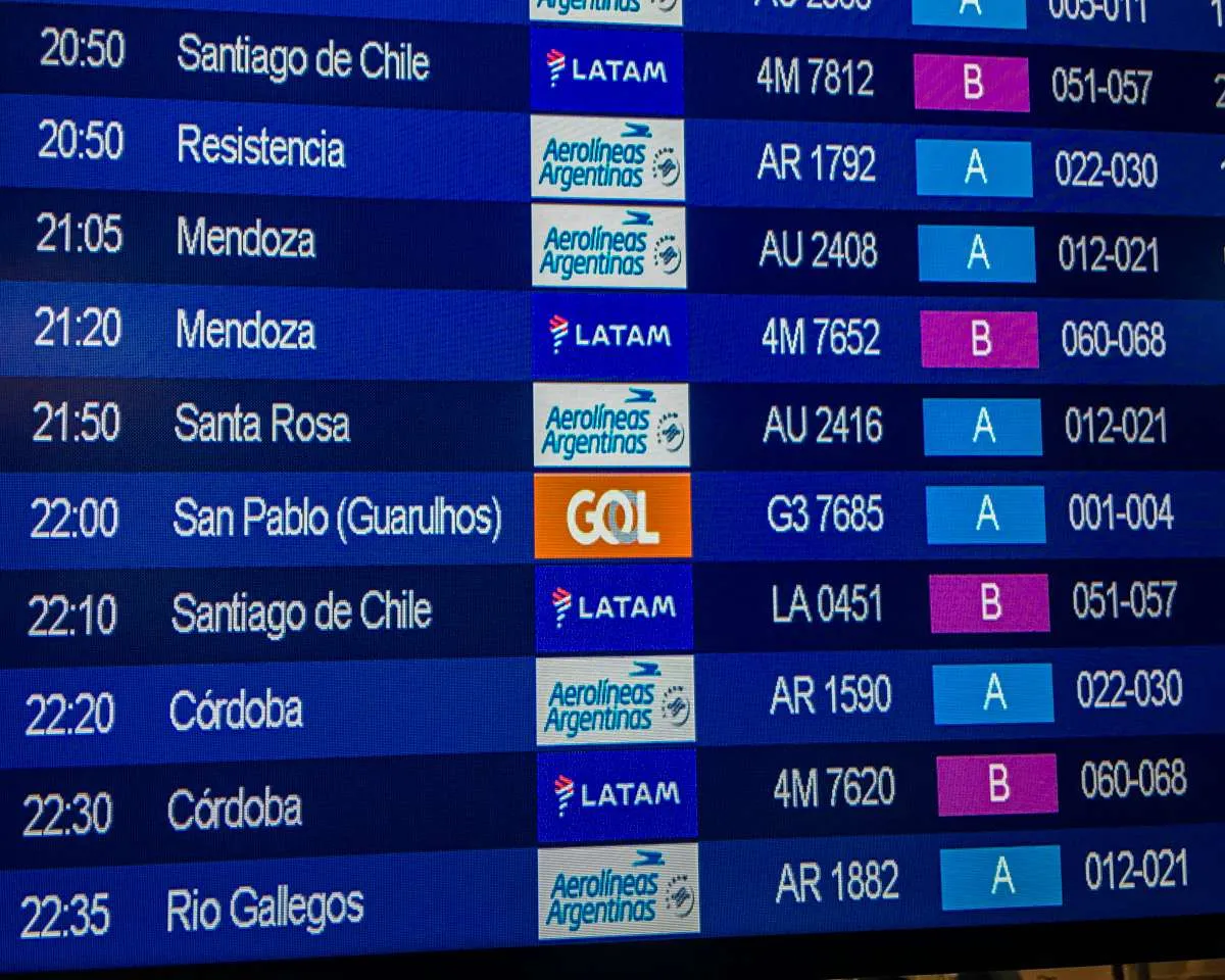 A sign at AEP Airport showing upcoming departures 