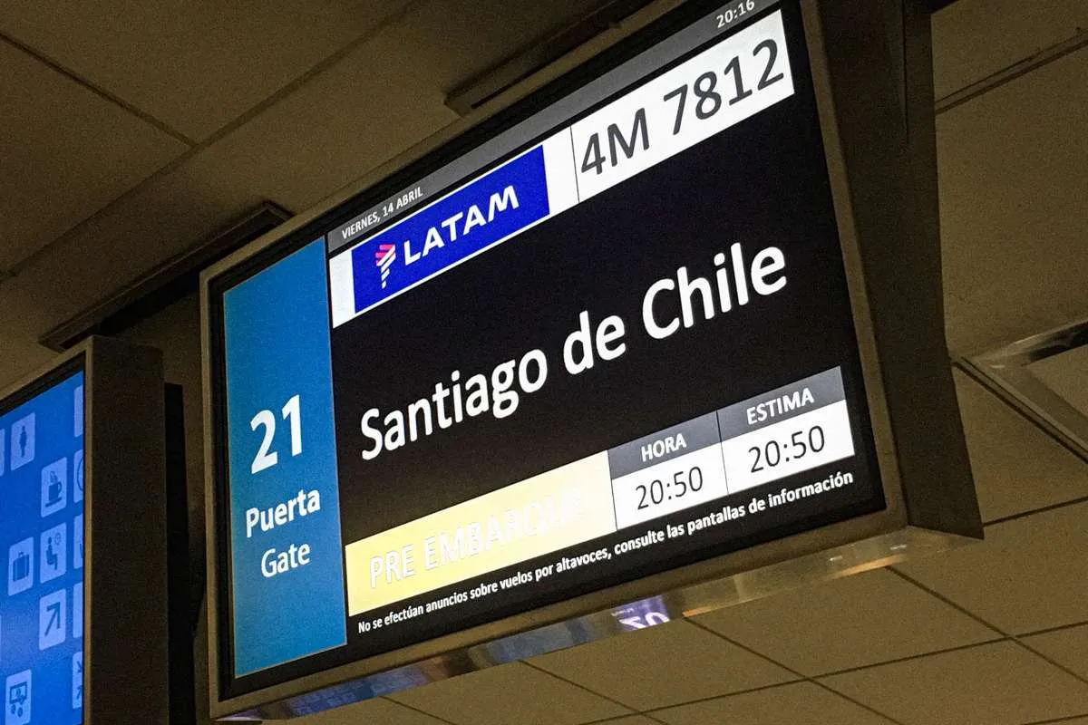 An airport gate sign reading Latam: Santiago de Chile, in AEP Airport Buenos Aires