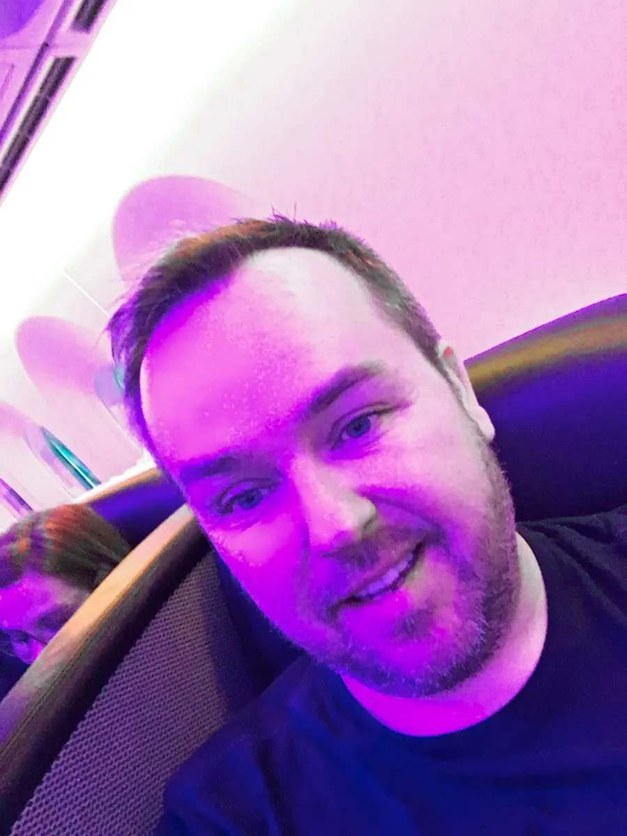 Patrick shown in the Upper Class cabin on board Virgin Atlantic 