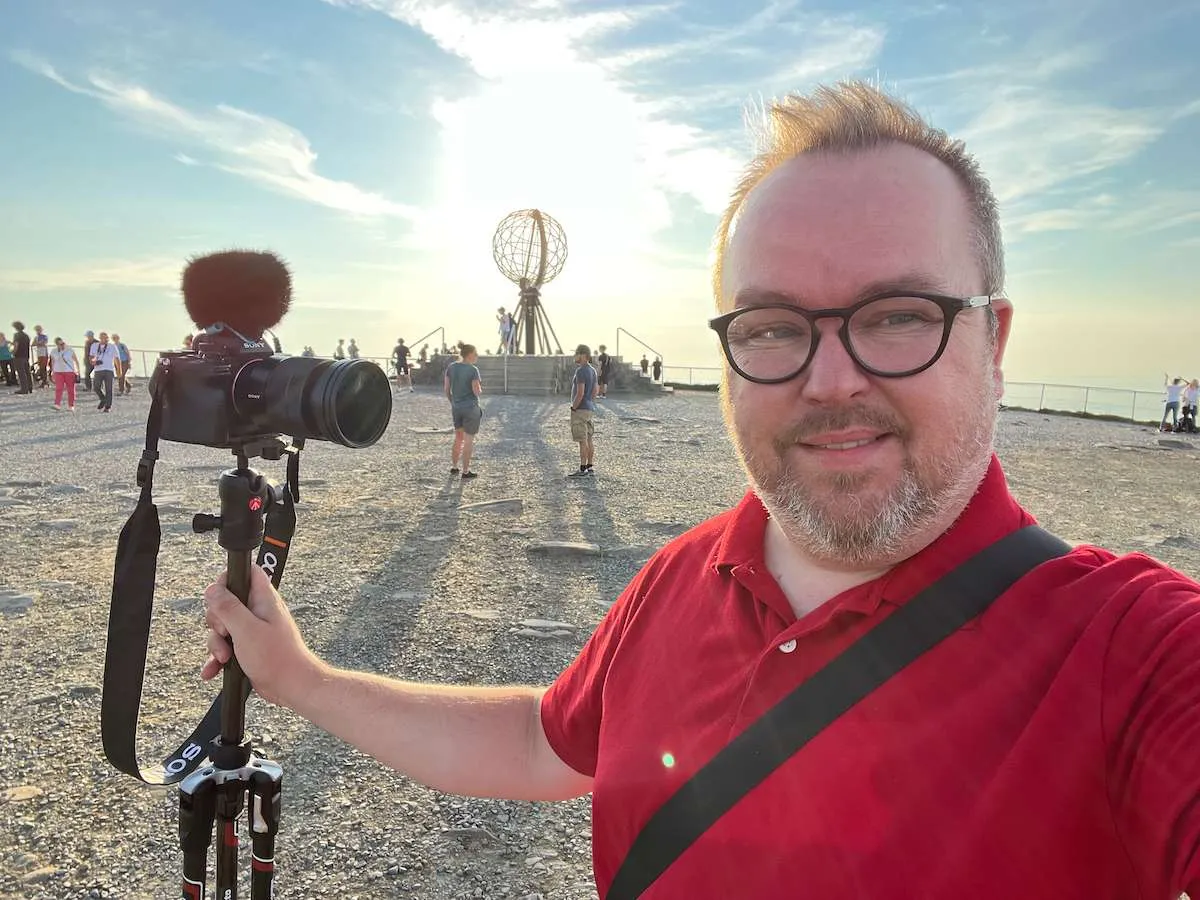 Picture shows Patrick holding a Sony A7 IV with its long strap - would a Peak Design Clutch be better?