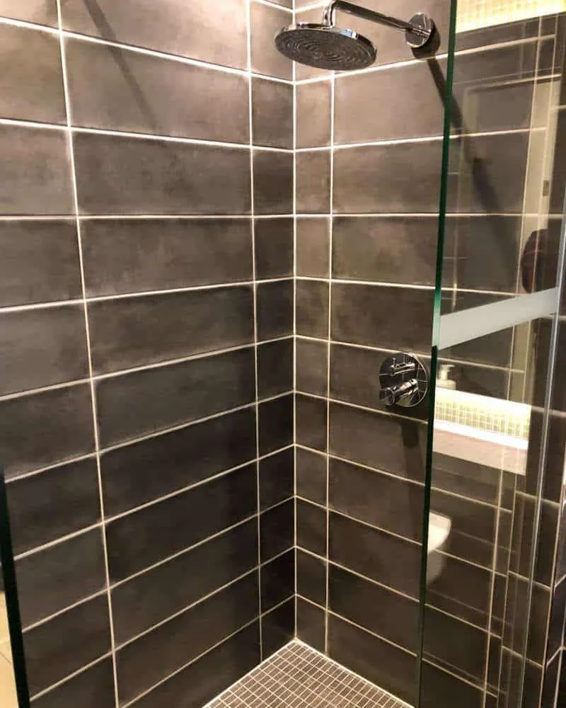 A large shower head in the private shower room 