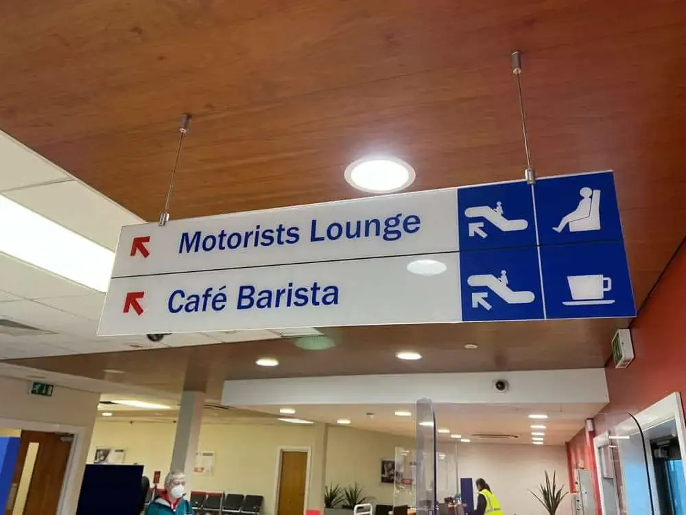 Inside the terminal at Belfast Port, a sign pointing to the Motorists Lounge and Cafe Barista 