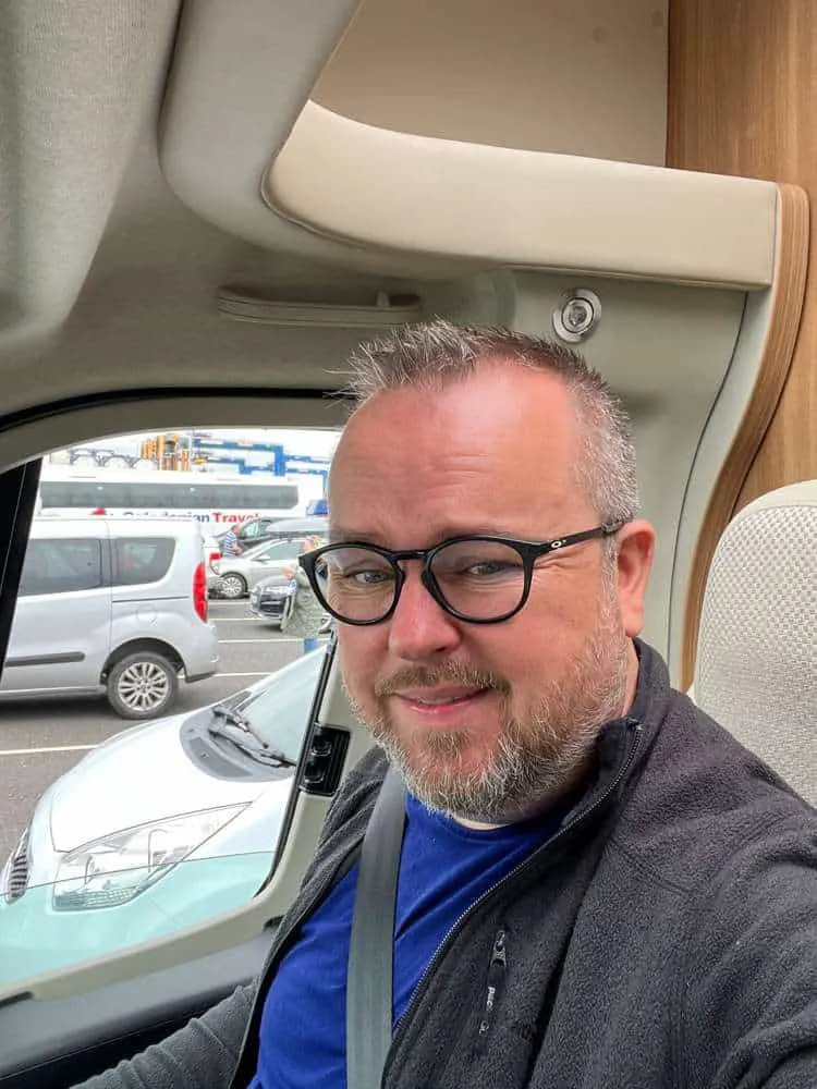 Patrick is shown waiting patiently in his campervan driving seat. 