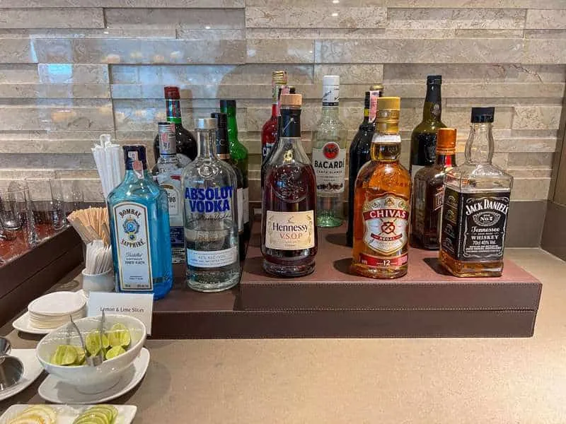A range of liquor bottles including gin and vodka, on a countertop at the Emirates Lounge in Bangkok 