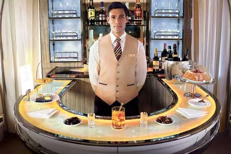 An image from Emirates Website showing a barman in the business class cabin