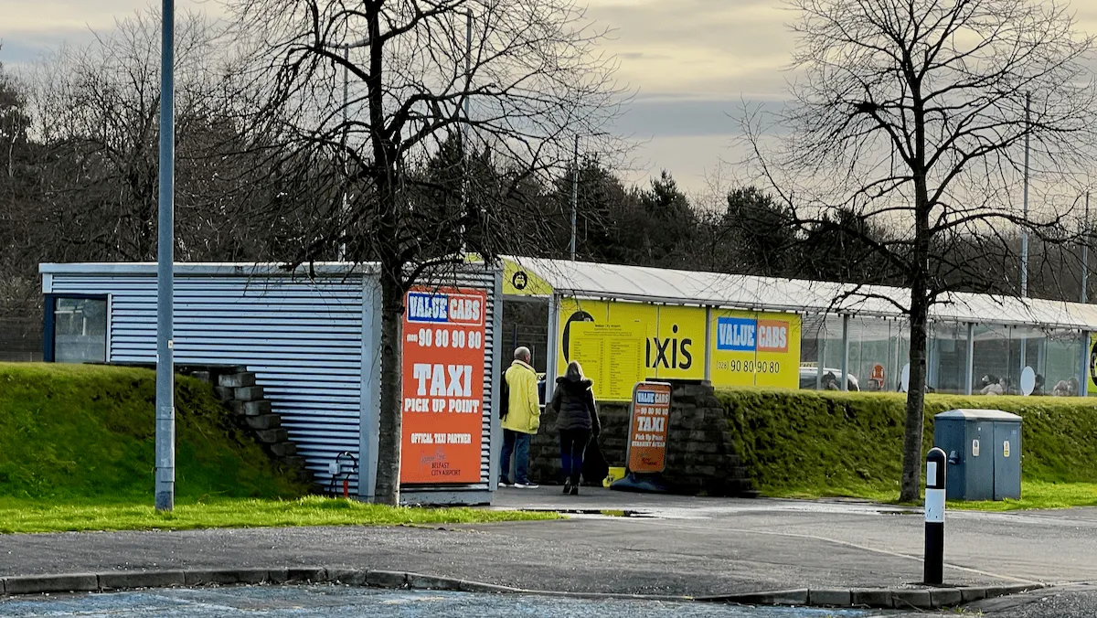 A bright yellow taxi stand at Belfast City Airport
