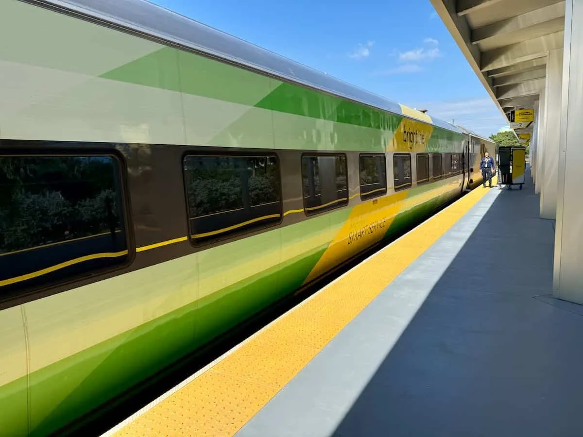 A Brightline train with signature green and yellow branding