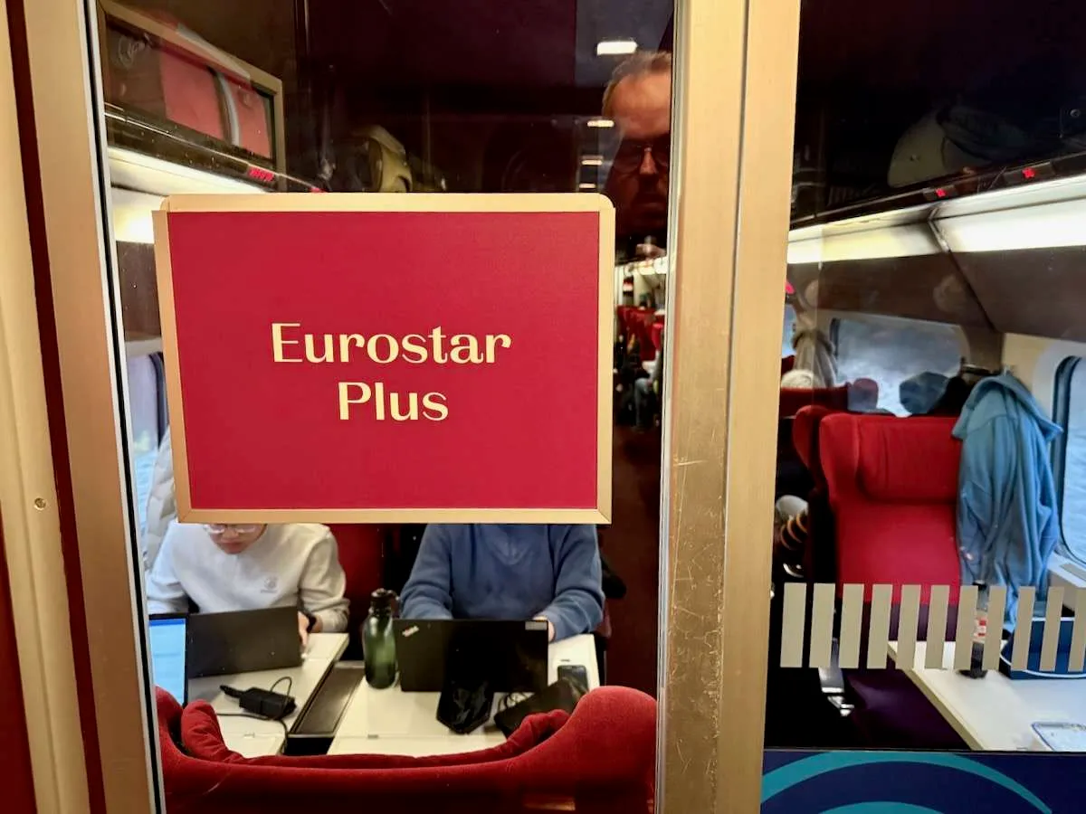 A red Eurostar Plus sign on glass doors