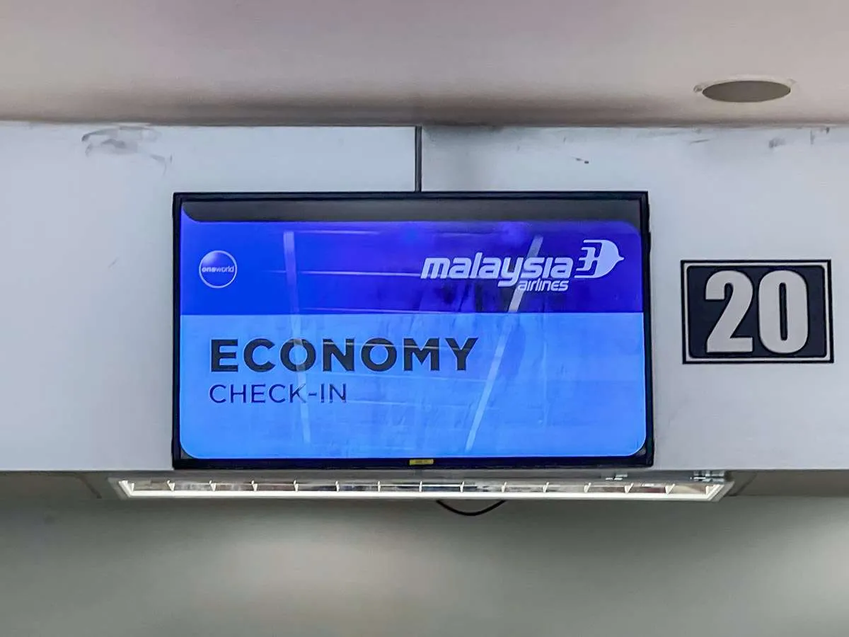 A sign reading "Economy" and "Malaysia Airlines" at Chiang Mai Airport