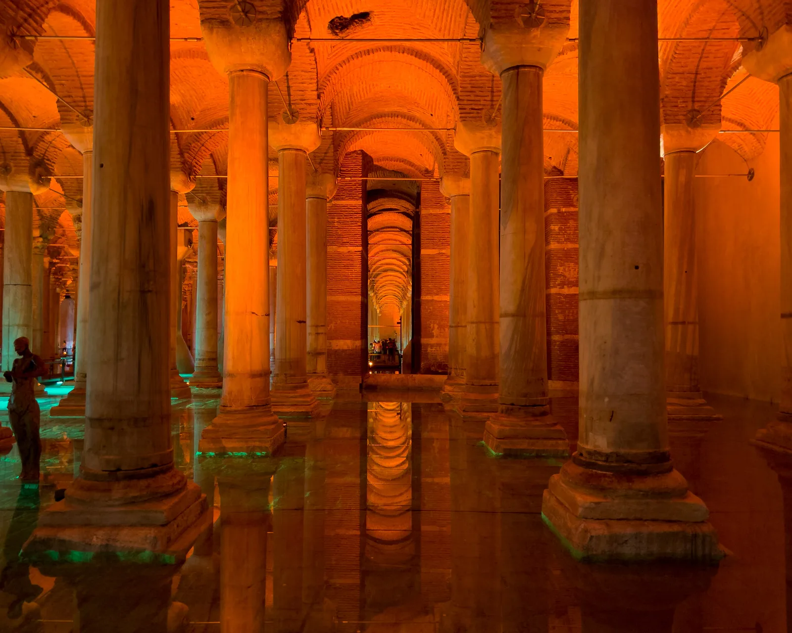Marble columns under warm light reflected in the shallow water of the Basilica Cistern, Istanbul