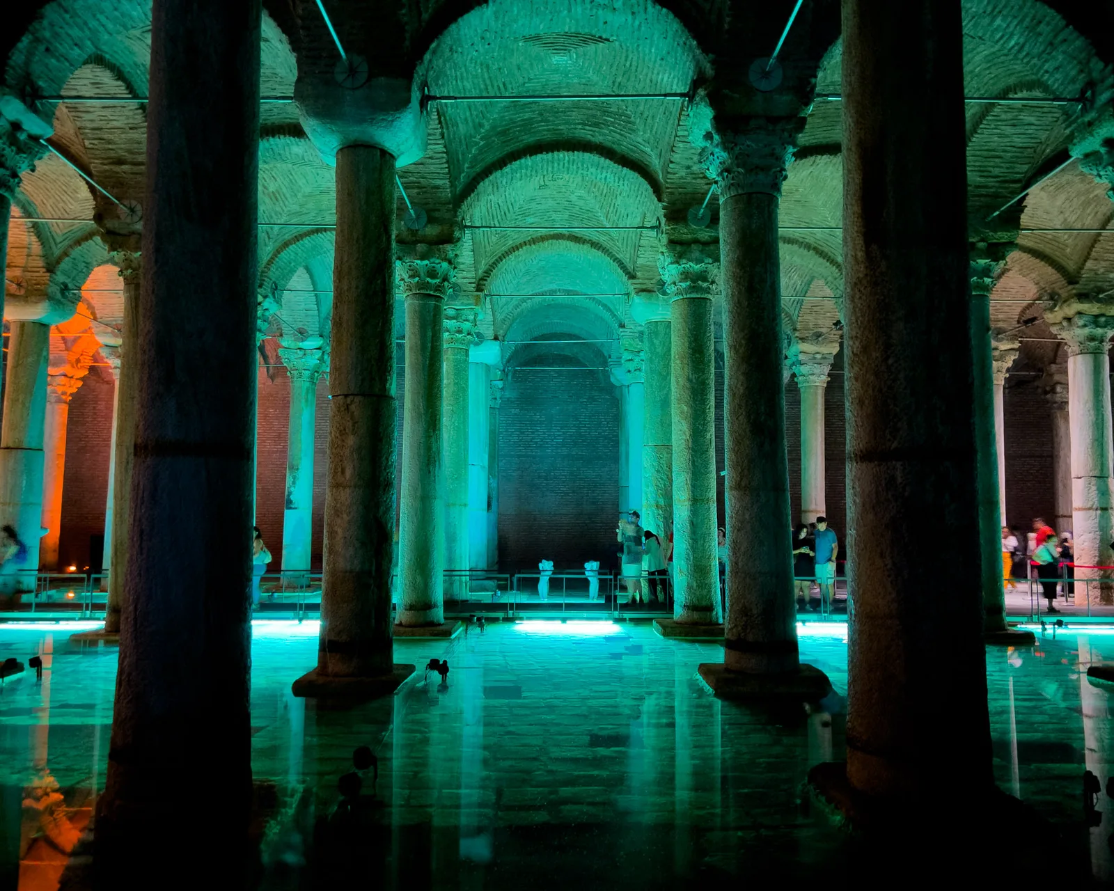 Basilica Cistern columns lit in deep teal and green, reflected in the water