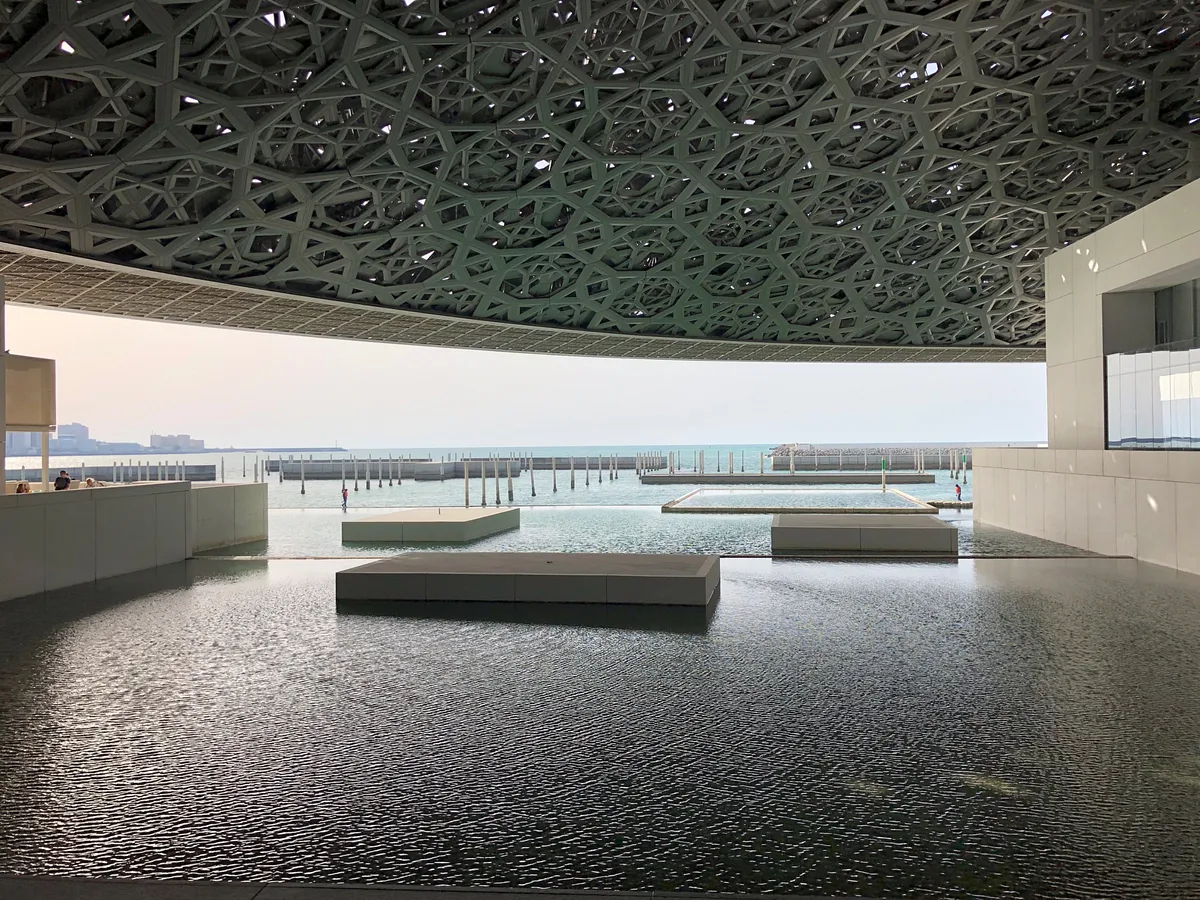 Geometric dome ceiling and water features at Louvre Abu Dhabi