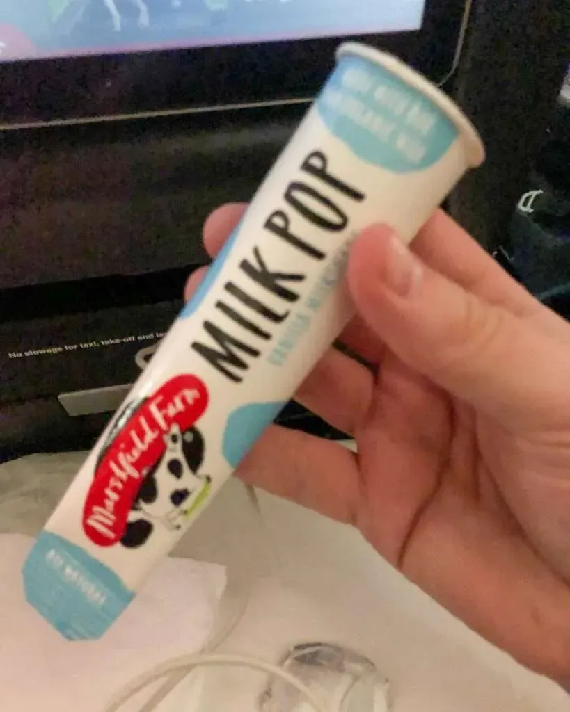 Mid-flight snack service on Qantas QF10 economy - calzone pizza and ice lolly