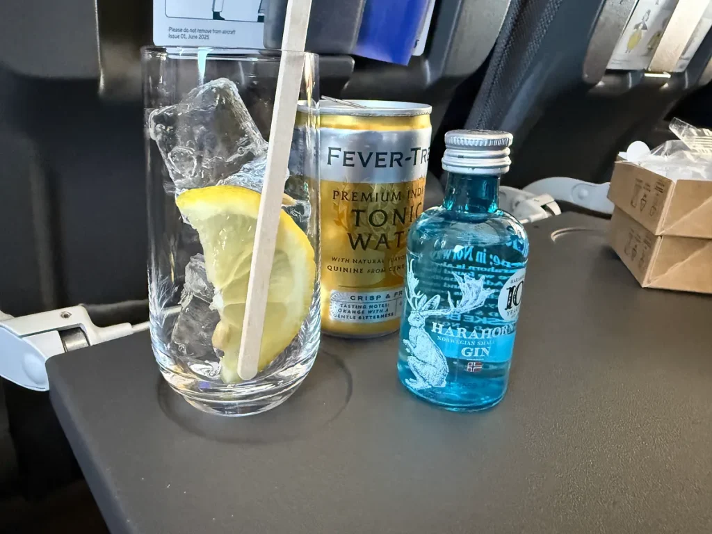 Gin and tonic with Harahorn Norwegian Small Batch Gin and Fever-Tree tonic on airplane tray table