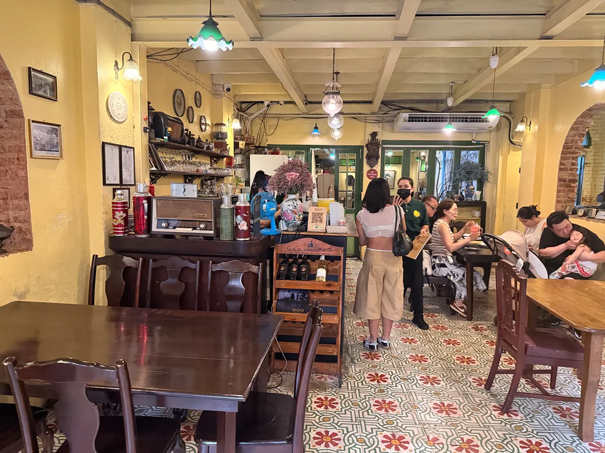 Traditional cafe interior with patterned tile floors and vintage decor in Phuket Old Town