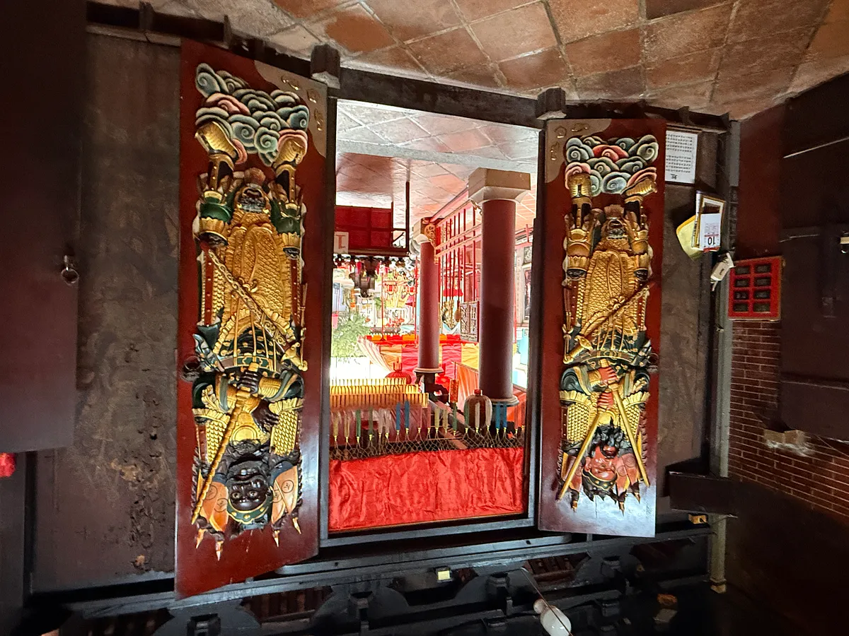 Ornate Chinese door guardians flanking entrance to restaurant in Phuket Old Town