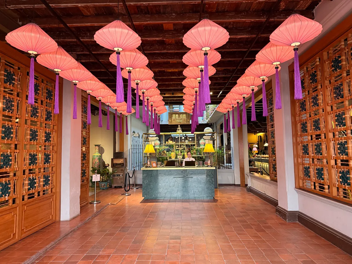 Pink lanterns with purple tassels hanging in hotel entrance, Phuket Old Town