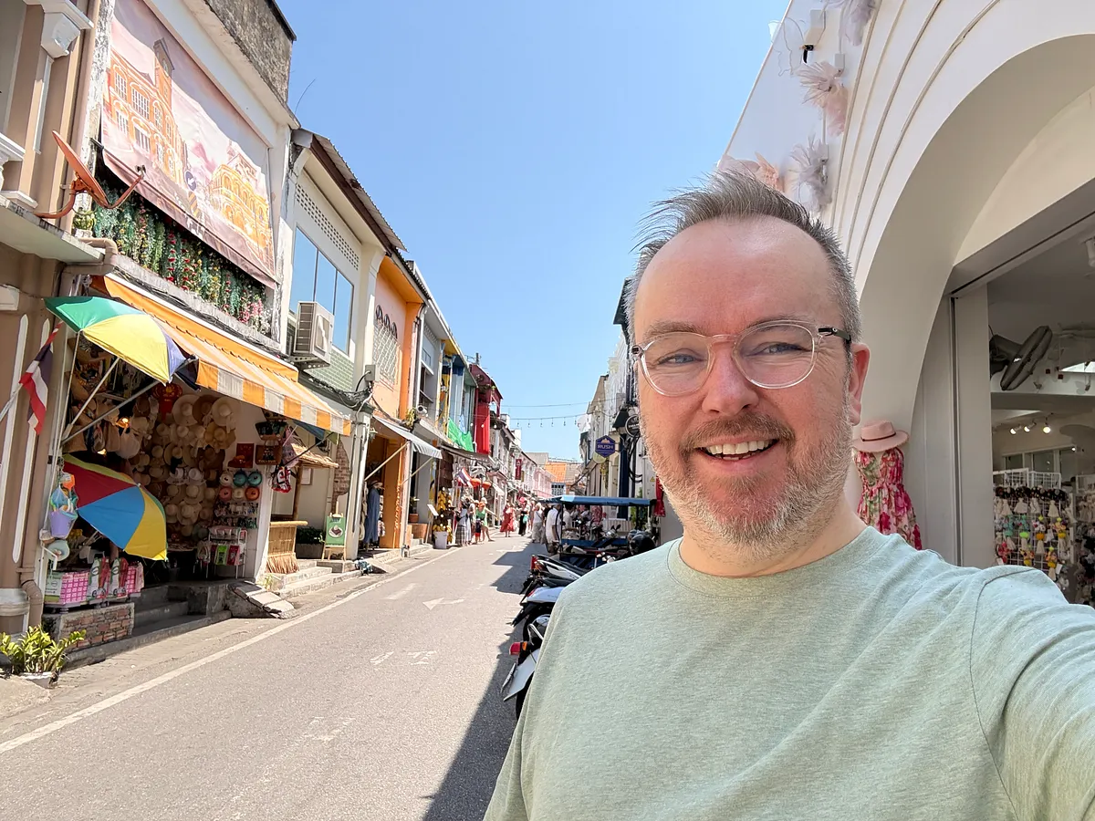 Solo traveler on a colorful street in Phuket Old Town with Sino-Portuguese shophouses