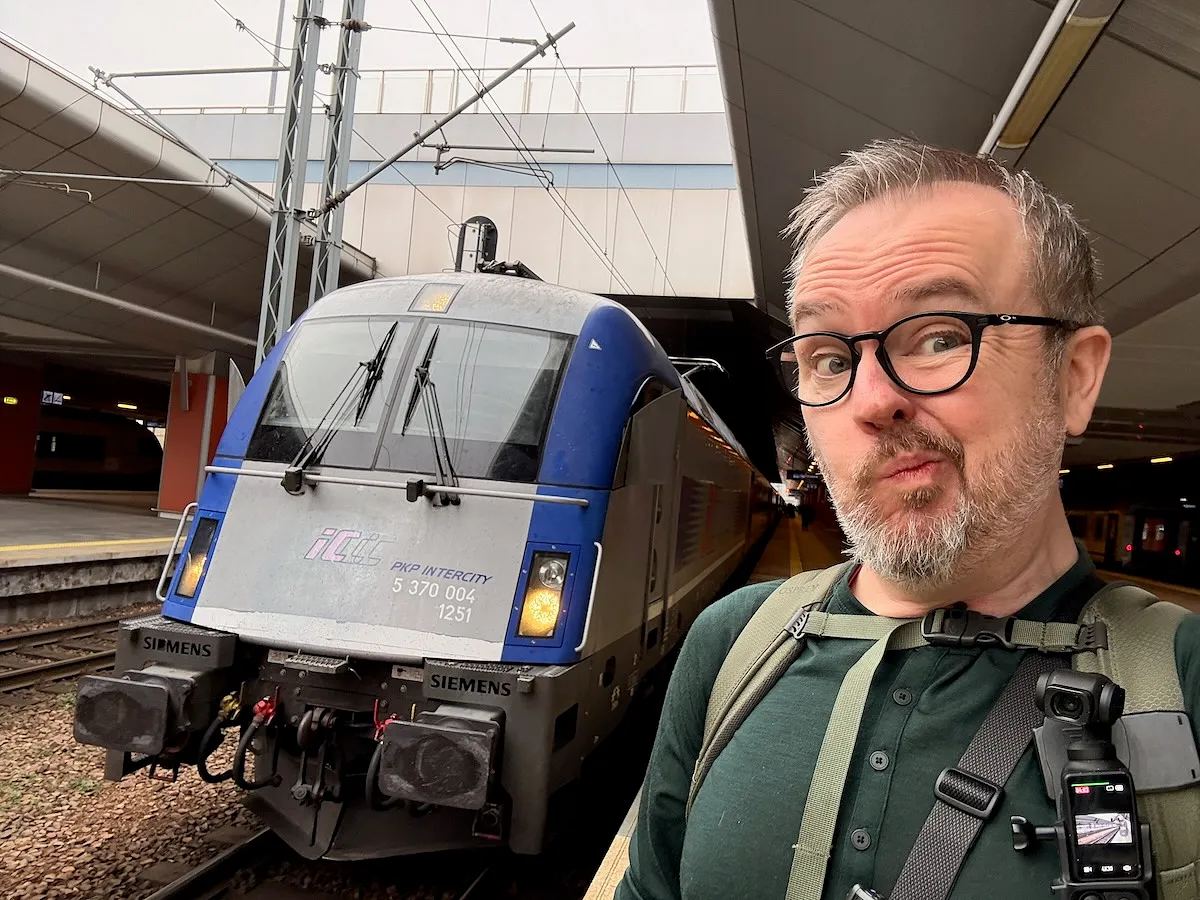 PKP Intercity Siemens Vectron locomotive at Polish railway station platform with traveler